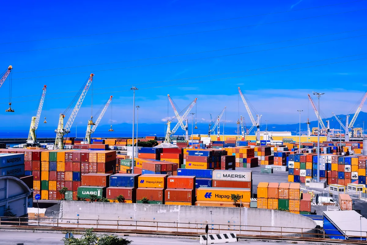 Shipping containers and cranes at a busy international port